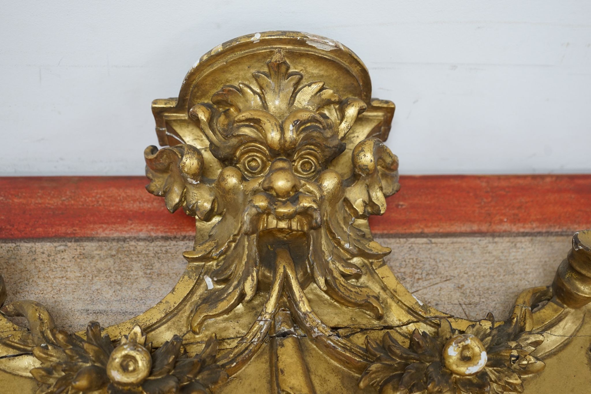 A 19th century carved giltwood pediment, width 142cm